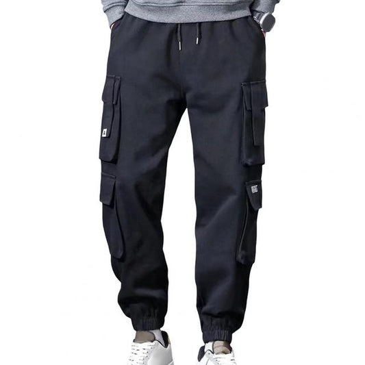 Black cargo pants worn by a person on a white background
